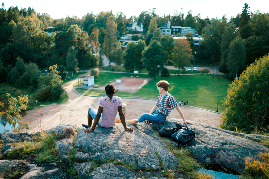 Two boys sitting on the rocks.